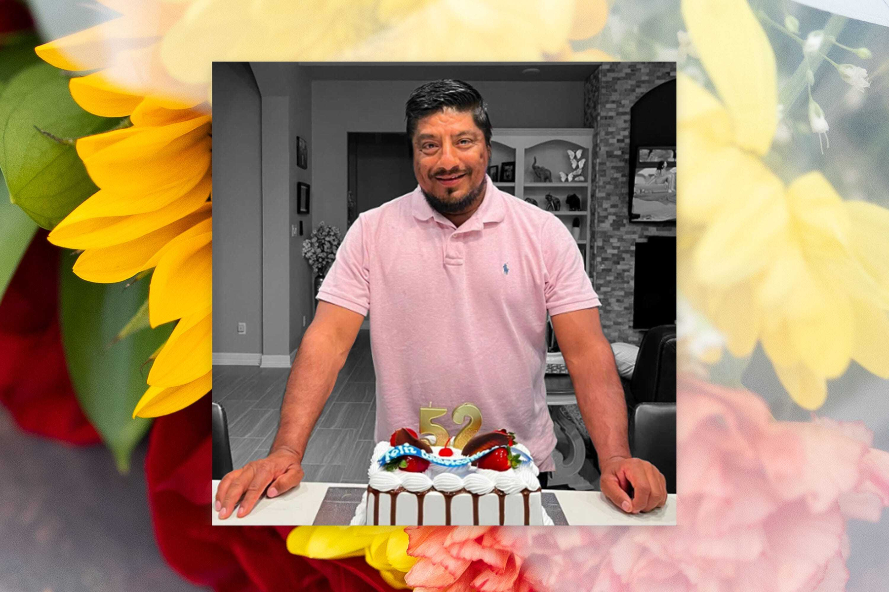 A photo of Lorenzo Salgado Araujo on his birthday in March. (Photo illustration by Sarah Rogers/The Bulwark | Original Photos: Salgado Araujo family, Getty. A smiling man celebrating his 52nd birthday stands behind a white-frosted cake decorated with chocolate drizzle, strawberries, and a gold “52” candle. He is wearing a light pink polo shirt. The central photograph utilizes a selective color effect with a black-and-white home interior background and is framed by a vibrant, soft-focus border overlay of bright yellow sunflowers and pinkish-red roses.